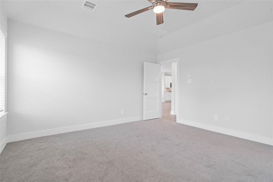 The private primary suite efficiently connects the sleeping area with the dedicated bathroom and generous closet. Note: Location of laundry room - directly across the primary bedroom entry door.