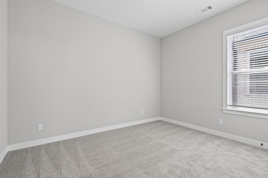 Unfurnished room featuring light carpet