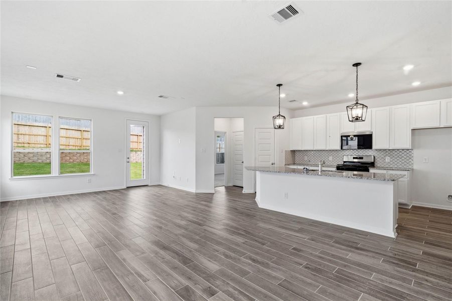 Stunning open-concept design seamlessly connecting the living, dining, and kitchen areas—perfect for both everyday living and entertaining! Stunning open-concept design seamlessly connecting the living, dining, and kitchen areas—perfect for both everyday living and entertaining!