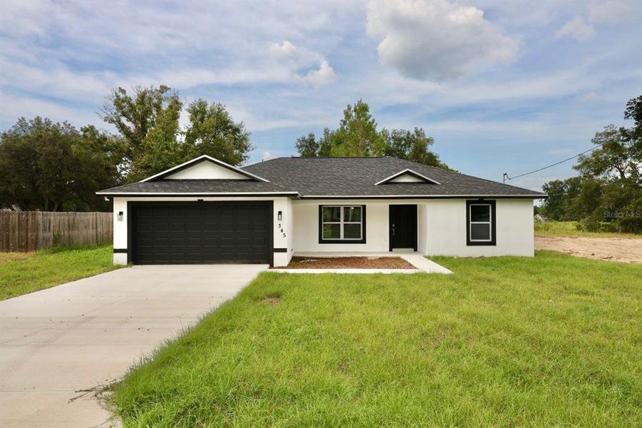 Front exterior of a new home in , Ocklawaha, FL, highlighting curb appeal (Image 2).