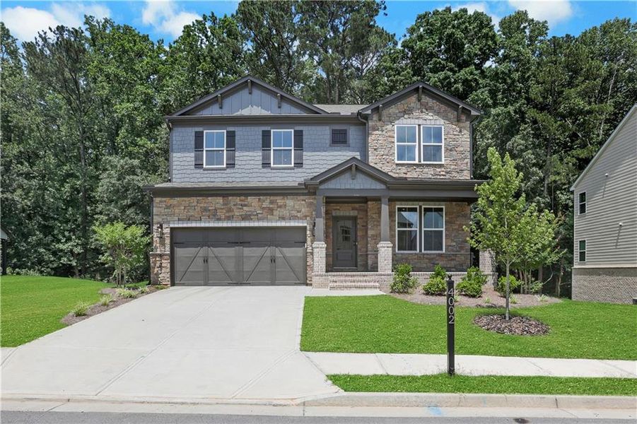 Front exterior of a new home in The Paddocks at Doc Hughes, Buford, GA, highlighting curb appeal (Image 28). Front exterior of a new home in The Paddocks at Doc Hughes, Buford, GA, highlighting curb appeal (Image 28).