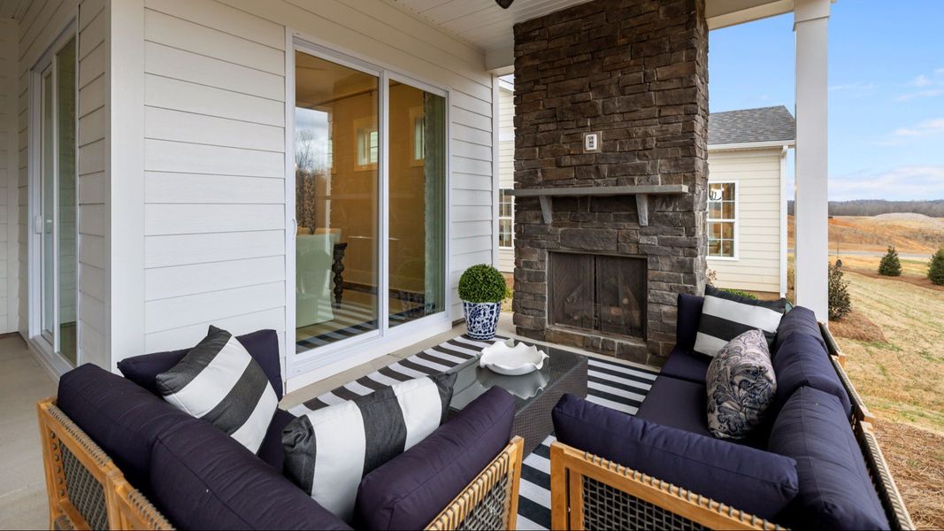 The Adventurer Plan by DBR Homes with a spacious rear porch and stone fireplace in Fort Mill, SC
