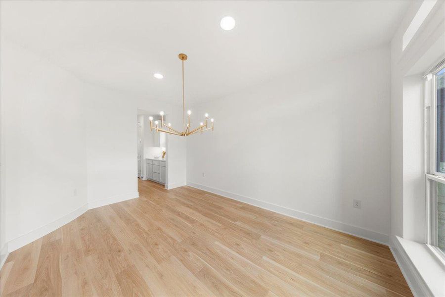 Unfurnished dining area with recessed lighting, light wood-style flooring, and a chandelier Unfurnished dining area with recessed lighting, light wood-style flooring, and a chandelier