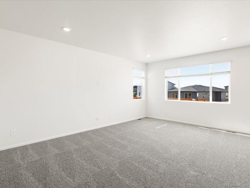 Spacious, unfurnished interior of a new home in Ridgeline Vista: The Flora Collection, Brighton (Image 25).