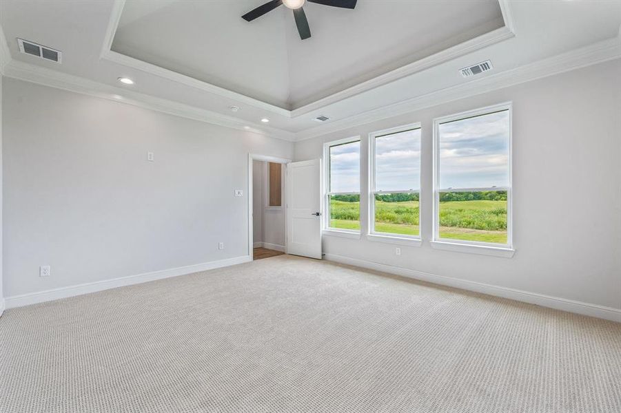 Unfurnished room with light colored carpet, crown molding, ceiling fan, baseboards, and recessed lighting