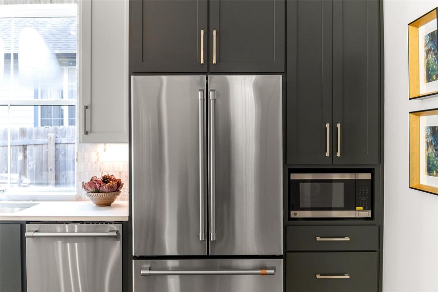 Kitchen with tasteful backsplash, a wealth of natural light, and appliances with stainless steel finishes