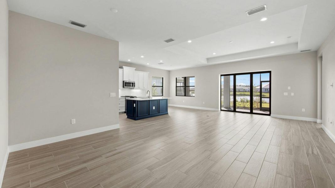 Spacious, unfurnished interior of a new home in SkySail Real Estate and Homes for Sale in Naples, FL - Neal Communities, Naples (Image 10).