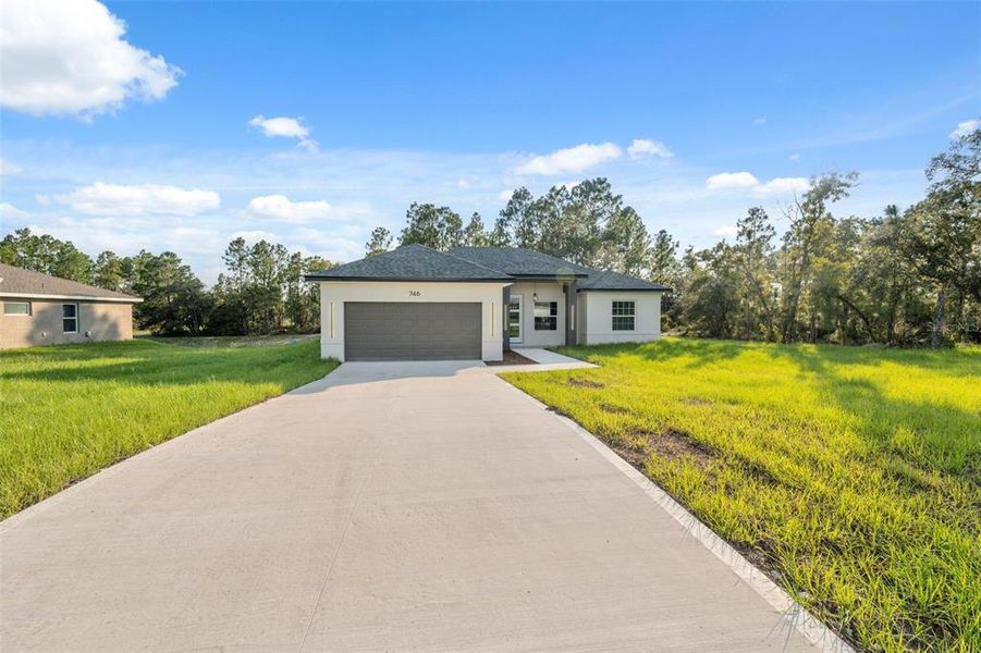 Front exterior of a new home in , Ocala, FL, highlighting curb appeal (Image 22).