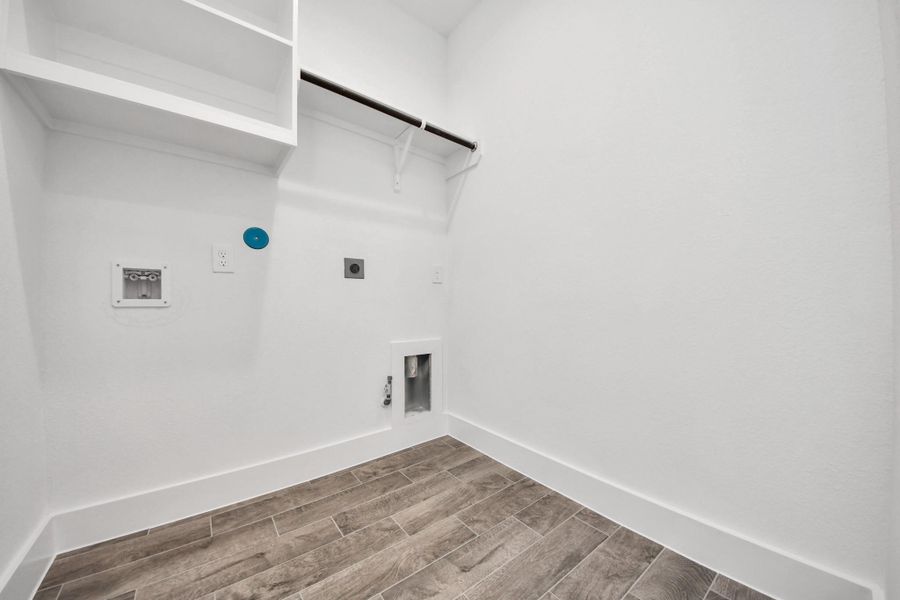 A perfect blend of functionality and comfort. Capture the essence of easy living with a first-floor laundry room, thoughtfully equipped with shelving for effortless organization. Both electric and gas connections available.