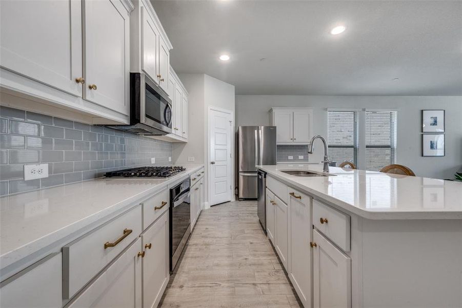 Expansive open-concept layout connects the kitchen, dining, mud room, and living area with natural flow.