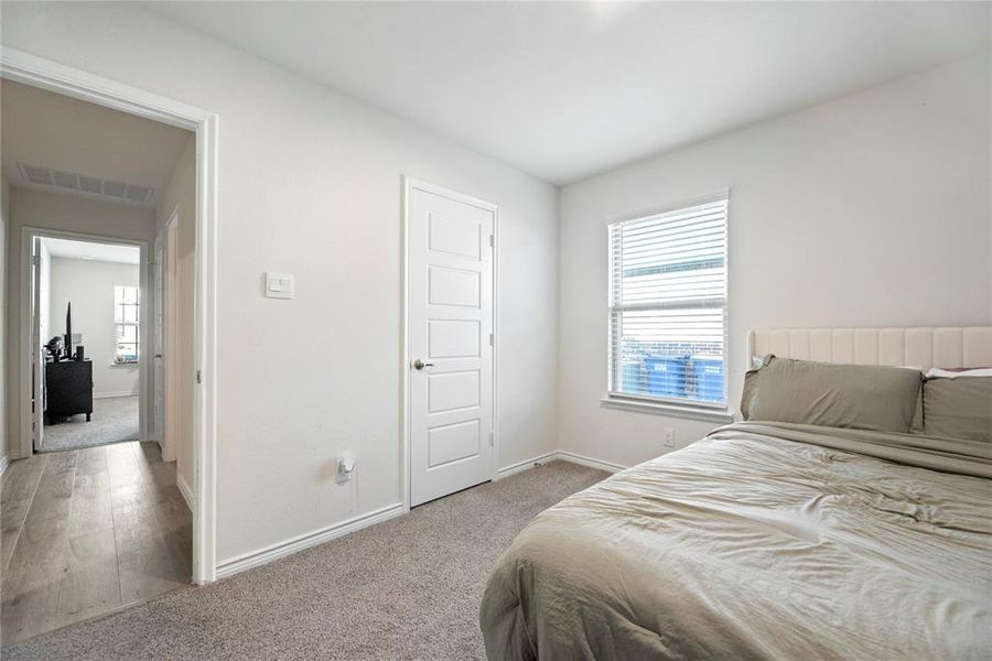 Bedroom featuring light carpet