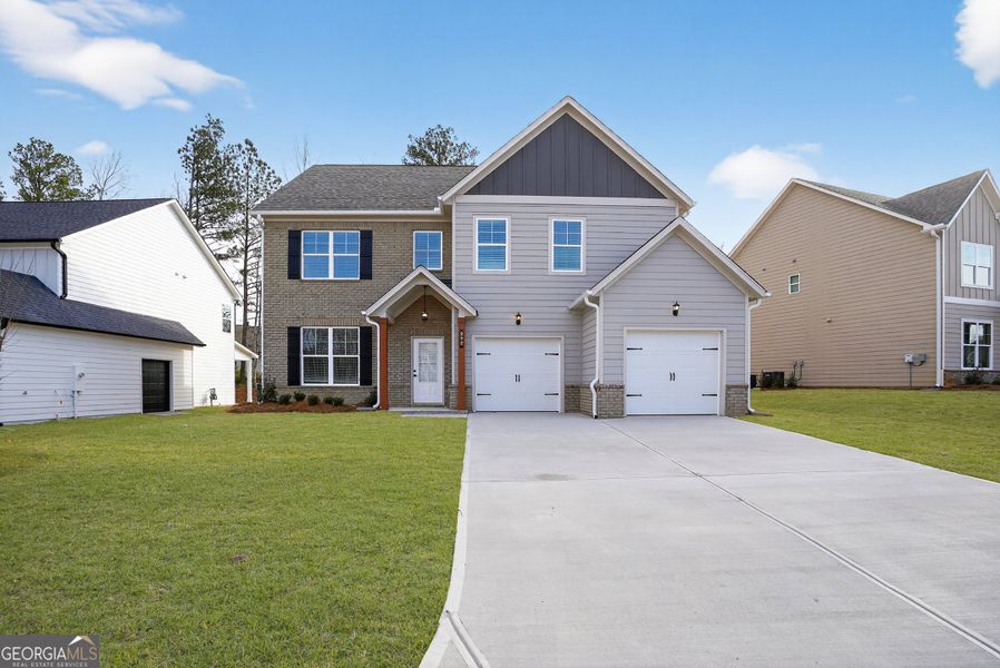 Front exterior of a new home in The Fairways at Mirror Lake, Villa Rica, GA, highlighting curb appeal (Image 1). Front exterior of a new home in The Fairways at Mirror Lake, Villa Rica, GA, highlighting curb appeal (Image 1).