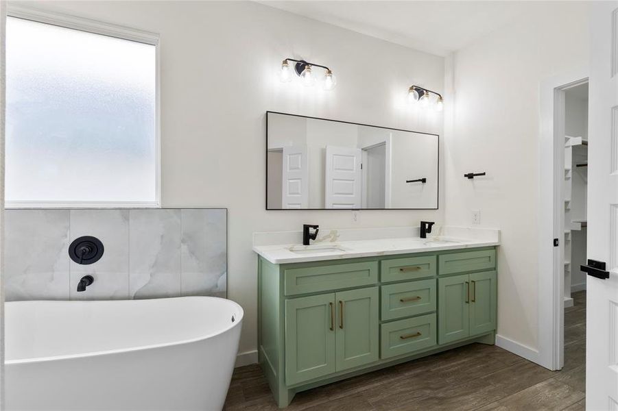 Freestanding white soaking tub with matte black fixtures