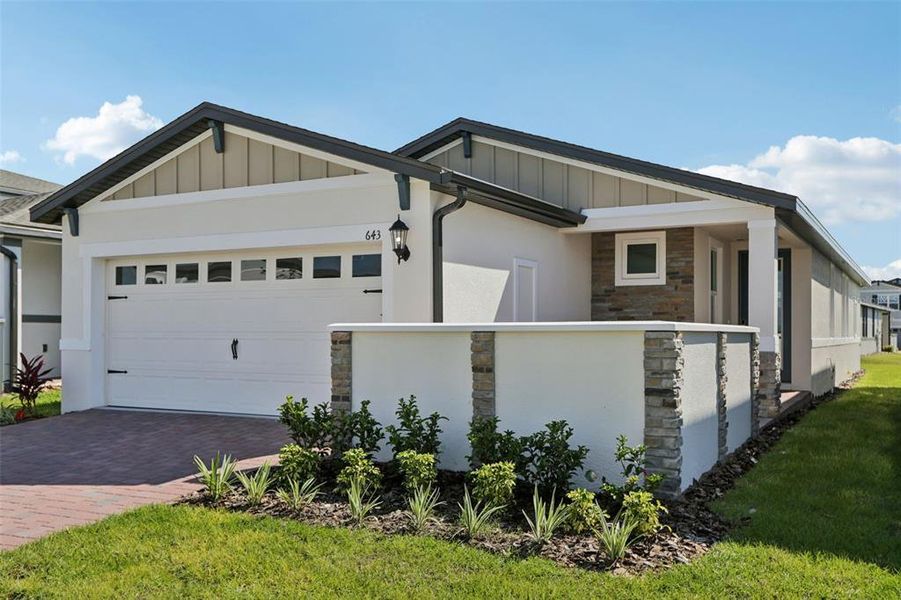 Front exterior of a new home in Springs at Lake Alfred - Classic Series, Lake Alfred, FL, highlighting curb appeal (Image 19).