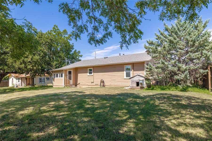 Rear view of property featuring a yard Rear view of property featuring a yard