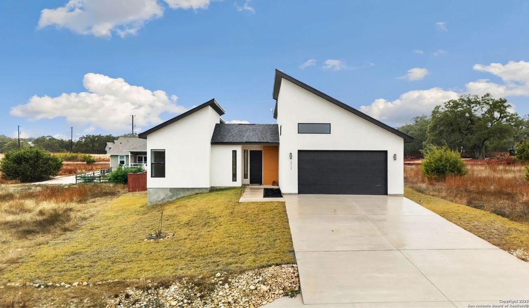 Front exterior of a new home in , Blanco, TX, highlighting curb appeal (Image 2).