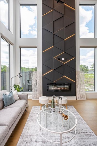 A sleek electric fireplace wrapped in an LED-lit feature wall creates an eye-catching focal point and elevates the living experience A sleek electric fireplace wrapped in an LED-lit feature wall creates an eye-catching focal point and elevates the living experience