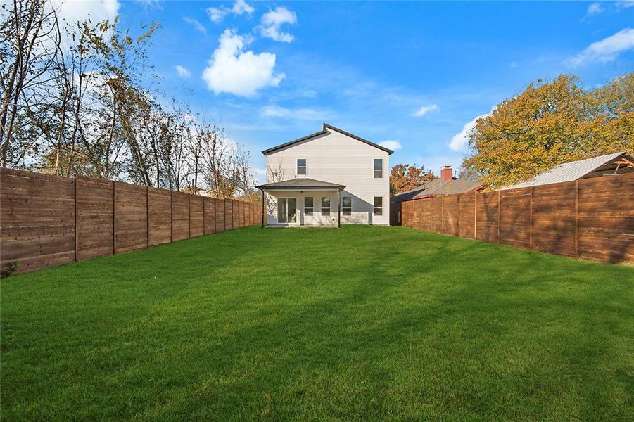 Rear view of property with a patio area and a fenced backyard Rear view of property with a patio area and a fenced backyard