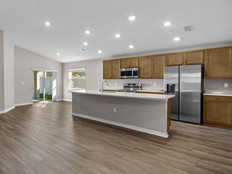 Your bright, open island kitchen includes quartz counters, 36-inch wood cabinets, Samsung appliances, and a walk-in pantry.