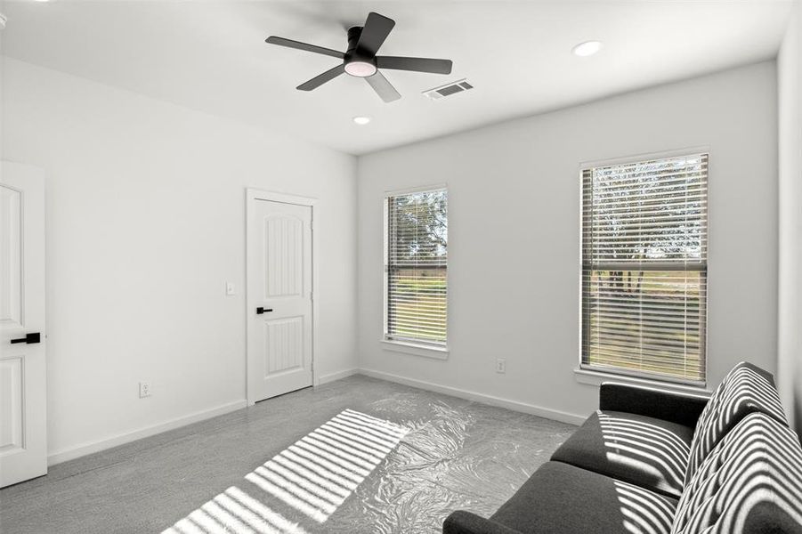 Living area featuring carpet floors, recessed lighting, and a ceiling fan