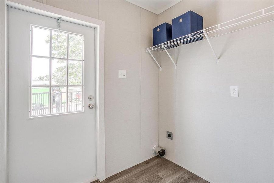 Laundry area featuring wood-type flooring and hookup for an electric dryer