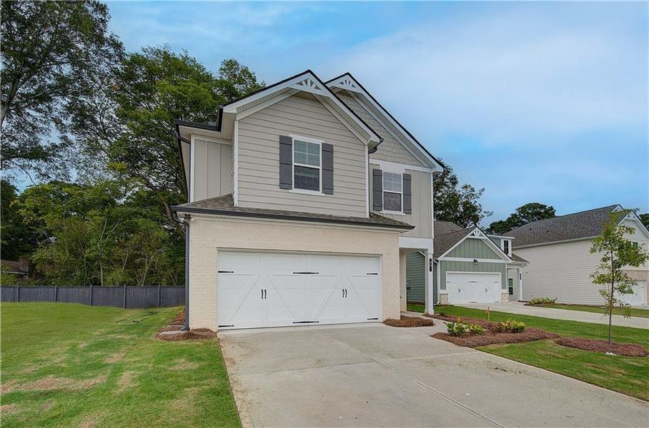 Front exterior of a new home in Abbotts Crossing, Conyers, GA, highlighting curb appeal (Image 18).
