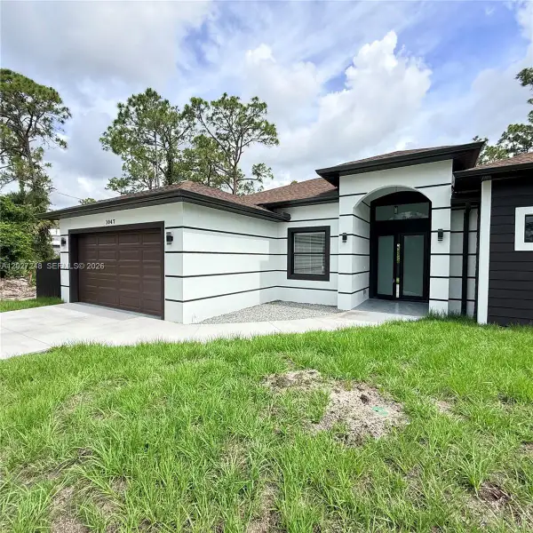 Front exterior of a new home in , Lehigh Acres, FL, highlighting curb appeal (Image 20).