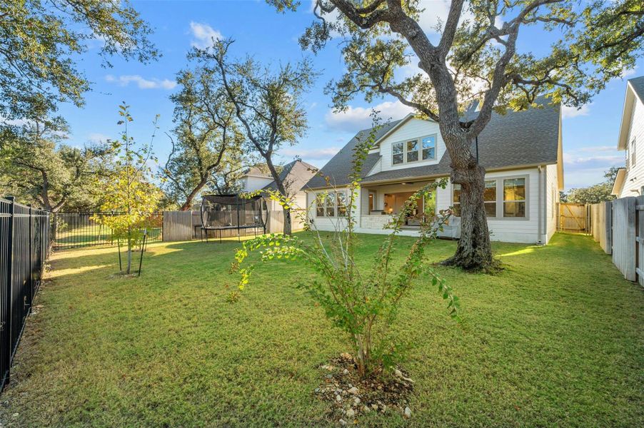 There’s also a sizable fenced-in backyard with towering mature shade trees and unobstructed hill country greenbelt views.