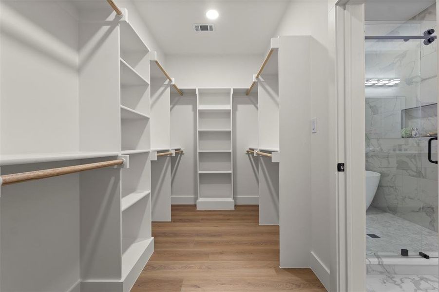 Spacious closet with light wood-type flooring