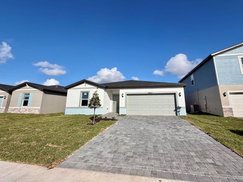 Front exterior of a new home in Meritage Homes at Terra Lago - Classic Series, Indiantown, FL, highlighting curb appeal (Image 10).