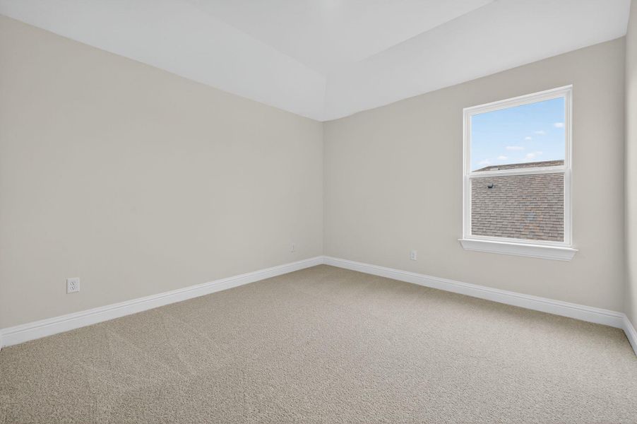 Carpeted spare room with baseboards