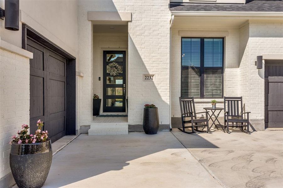View of exterior entry featuring roof with shingles and brick siding View of exterior entry featuring roof with shingles and brick siding