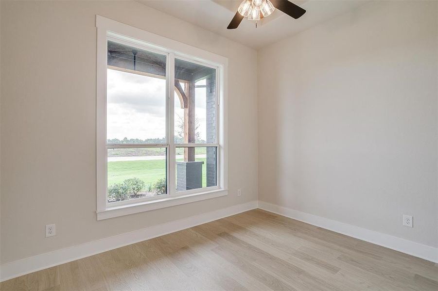 Empty room with light wood-type flooring and ceiling fan