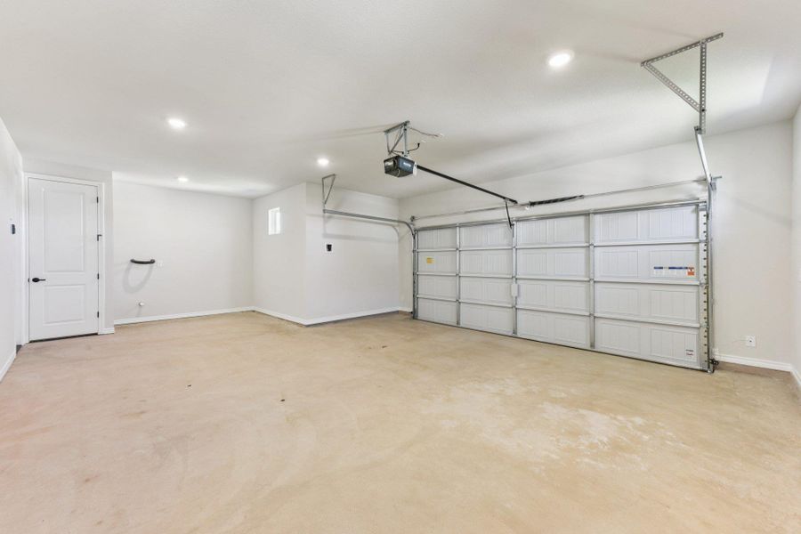 Garage with recessed lighting and a garage door opener