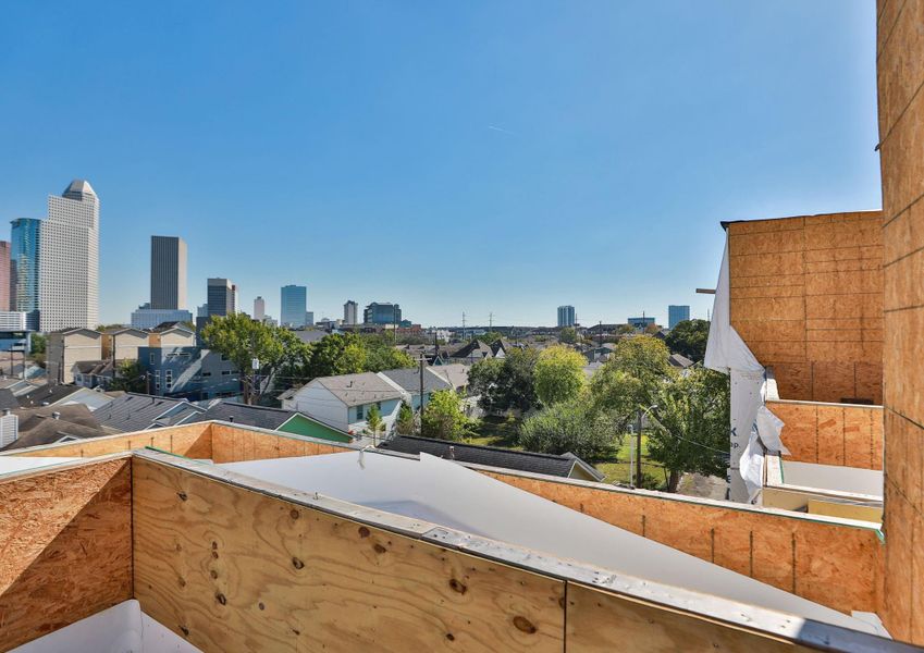 This photo showcases a rooftop view from a construction site with a city skyline in the background. The setting is urban, featuring nearby residential areas and greenery. The clear sky adds to the expansive view. This photo showcases a rooftop view from a construction site with a city skyline in the background. The setting is urban, featuring nearby residential areas and greenery. The clear sky adds to the expansive view.