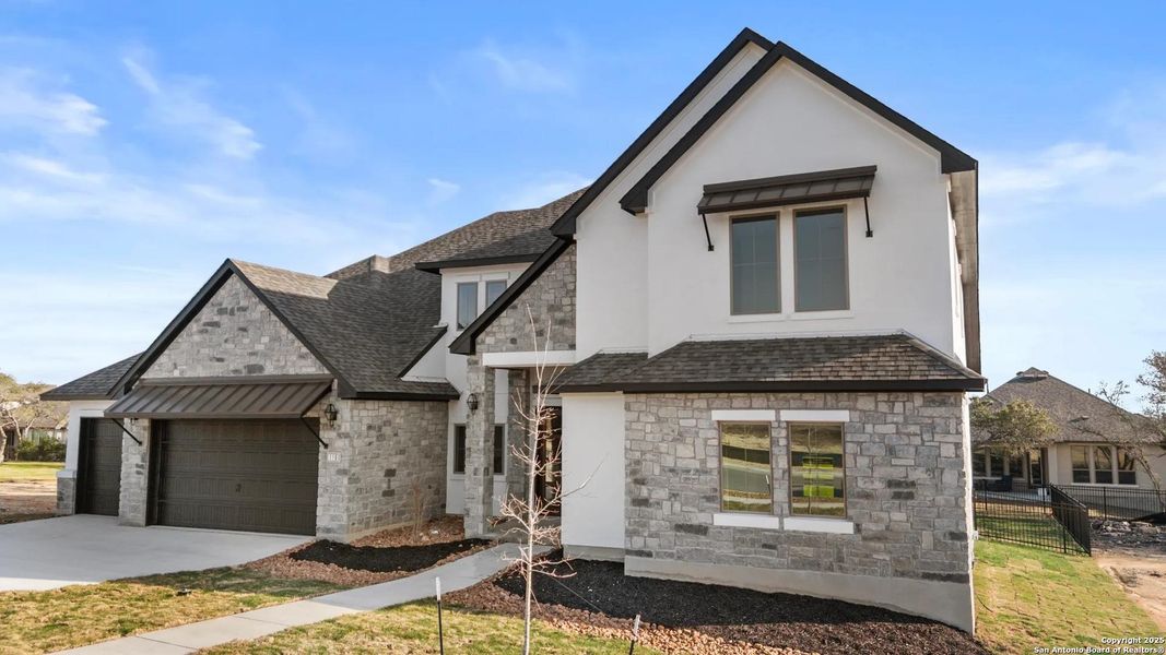 Front exterior of a new home in Esperanza - 80' & 90', Boerne, TX, highlighting curb appeal (Image 1). Front exterior of a new home in Esperanza - 80' & 90', Boerne, TX, highlighting curb appeal (Image 1).