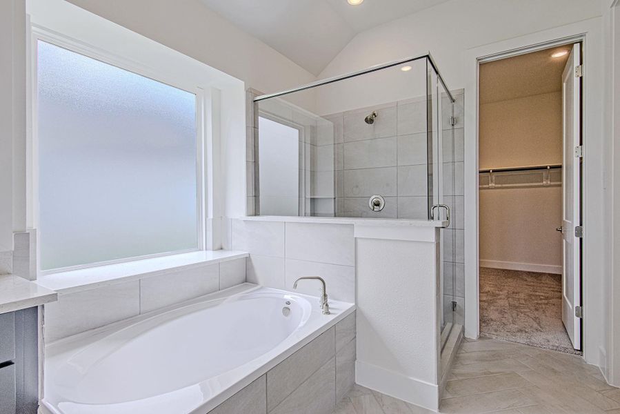 Well-appointed bathing area with glass-enclosed shower and relaxing garden tub Well-appointed bathing area with glass-enclosed shower and relaxing garden tub