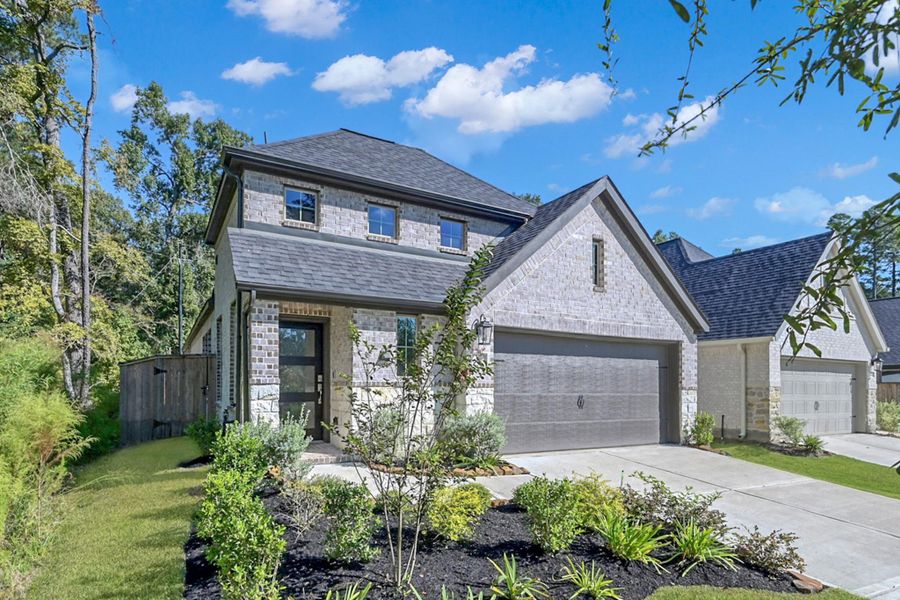 Front exterior of a new home in Woodforest 40', Montgomery, TX, highlighting curb appeal (Image 24).