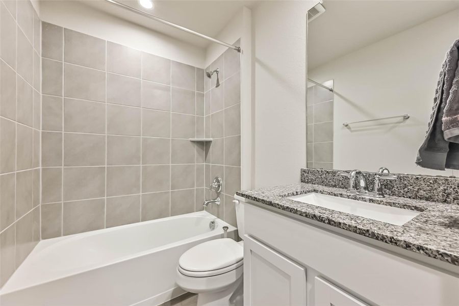 Sparkling second full bathroom with clean finishes and shower/tub combo.