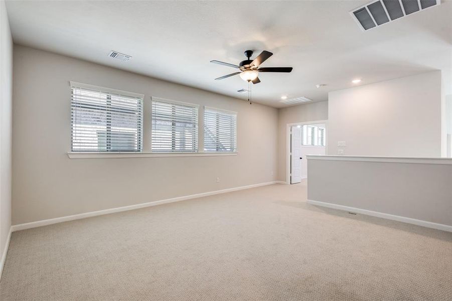 Unfurnished room with light carpet, ceiling fan, and recessed lighting