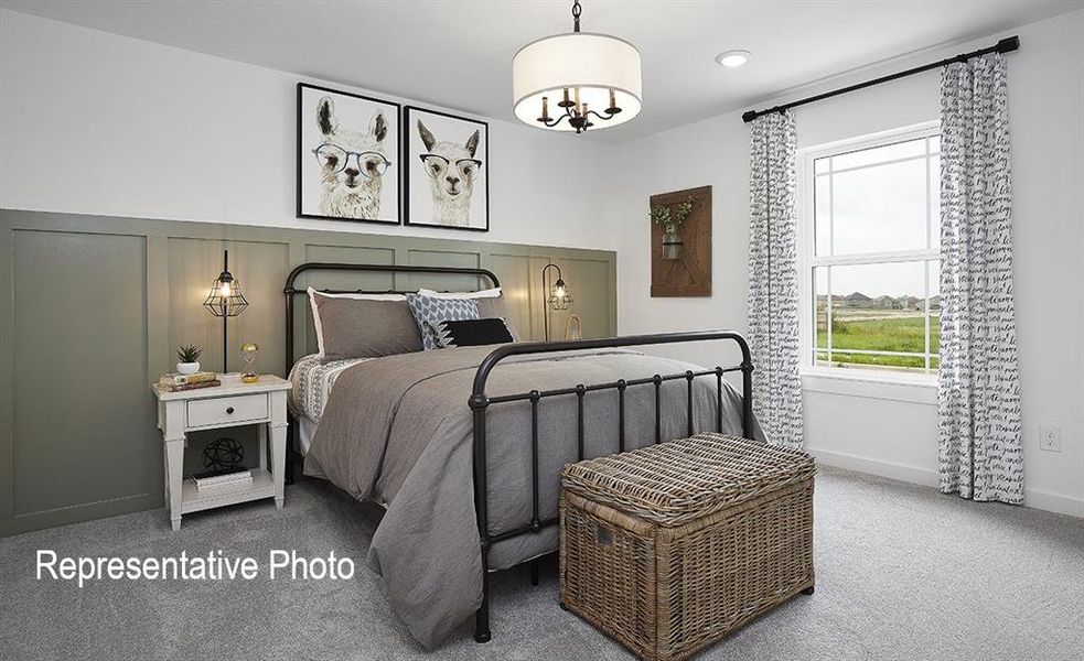 Carpeted bedroom with a chandelier