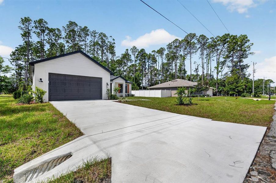 Front exterior of a new home in , Palm Coast, FL, highlighting curb appeal (Image 26). Front exterior of a new home in , Palm Coast, FL, highlighting curb appeal (Image 26).
