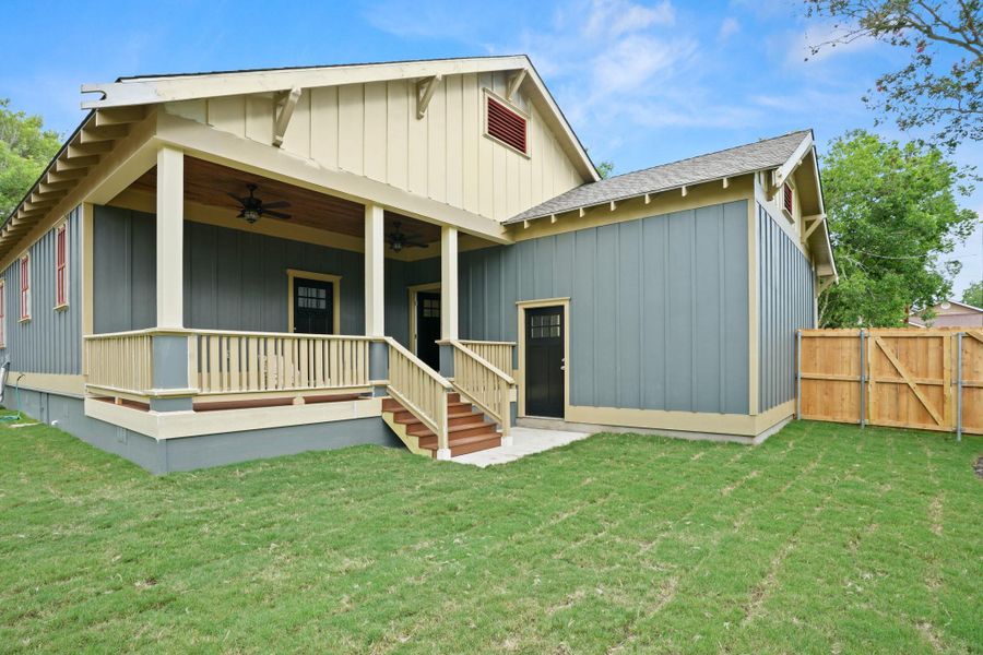 A welcoming rear porch offers comfortable outdoor living space overlooking a lush green yard. A welcoming rear porch offers comfortable outdoor living space overlooking a lush green yard.