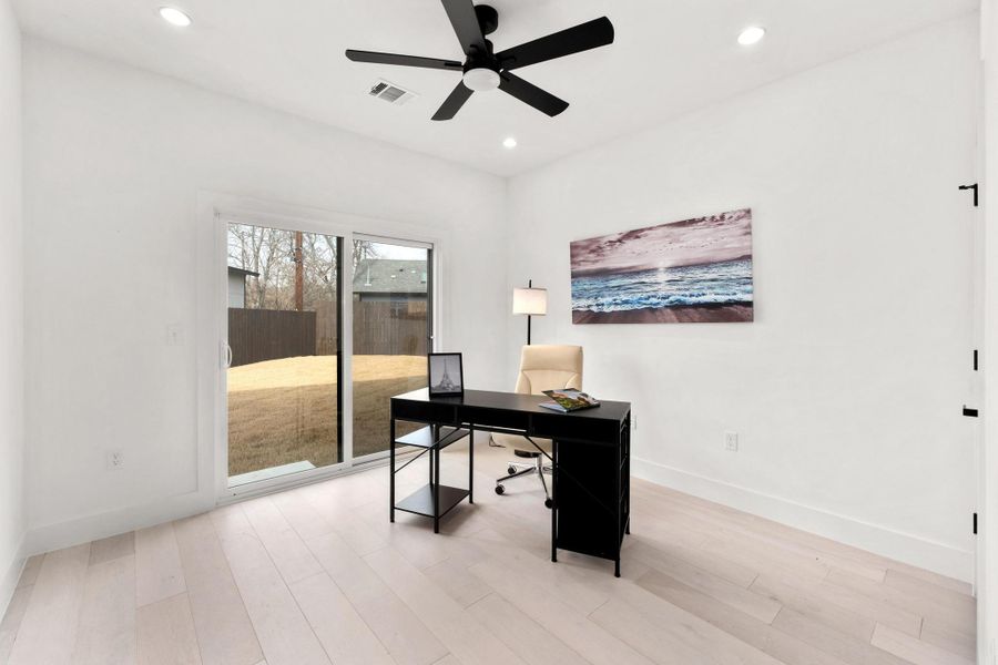 Office space with a ceiling fan, light wood-type flooring, and recessed lighting