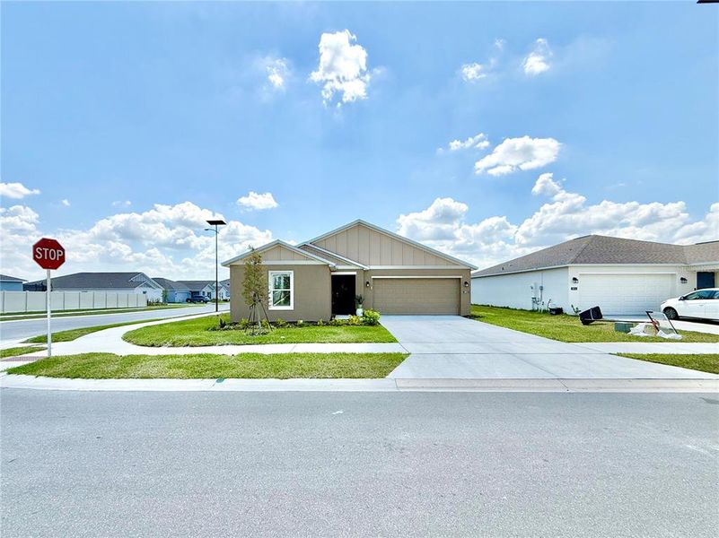 Front exterior of a new home in Ranches at Lake McLeod, Eagle Lake, FL, highlighting curb appeal (Image 21).
