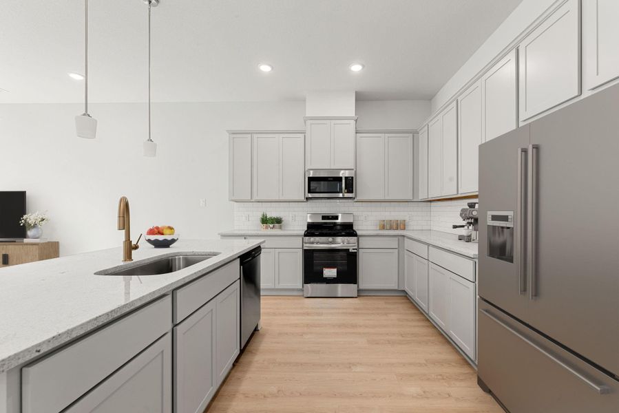 This stylish kitchen combines modern finishes with functionality, featuring stainless steel appliances, sleek cabinetry, and a large island offering ample workspace. The open layout provides a natural flow, while warm flooring and pendant lighting add an inviting, contemporary touch. This stylish kitchen combines modern finishes with functionality, featuring stainless steel appliances, sleek cabinetry, and a large island offering ample workspace. The open layout provides a natural flow, while warm flooring and pendant lighting add an inviting, contemporary touch.