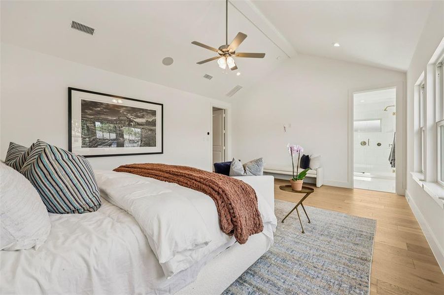 Vaulted ceiling bedroom featuring wood-finish flooring, a ceiling fan with integrated lighting, recessed lighting, and multiple windows