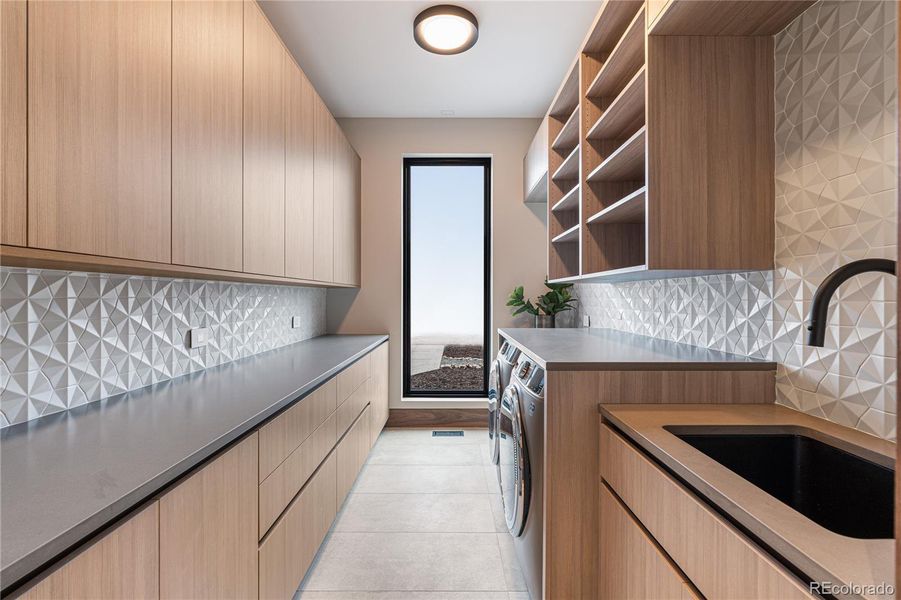 Two laundry rooms, one on each level. Providing abundant Shiloh Cabinetry & Pental Quartz folding counters. Upper level laundry provides 2 separate stackable washer/dryers. Blanco Anthracite Sink Basin, California Corsano Pull Down Faucets & GE Appliances