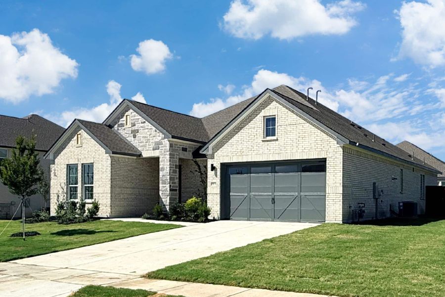 Front exterior of a new home in Polo Ridge, Mesquite, TX, highlighting curb appeal (Image 2). Front exterior of a new home in Polo Ridge, Mesquite, TX, highlighting curb appeal (Image 2).
