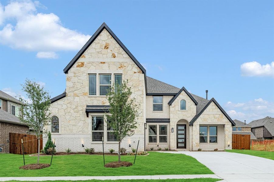 Front exterior of a new home in The Oaks, Red Oak, TX, highlighting curb appeal (Image 2).